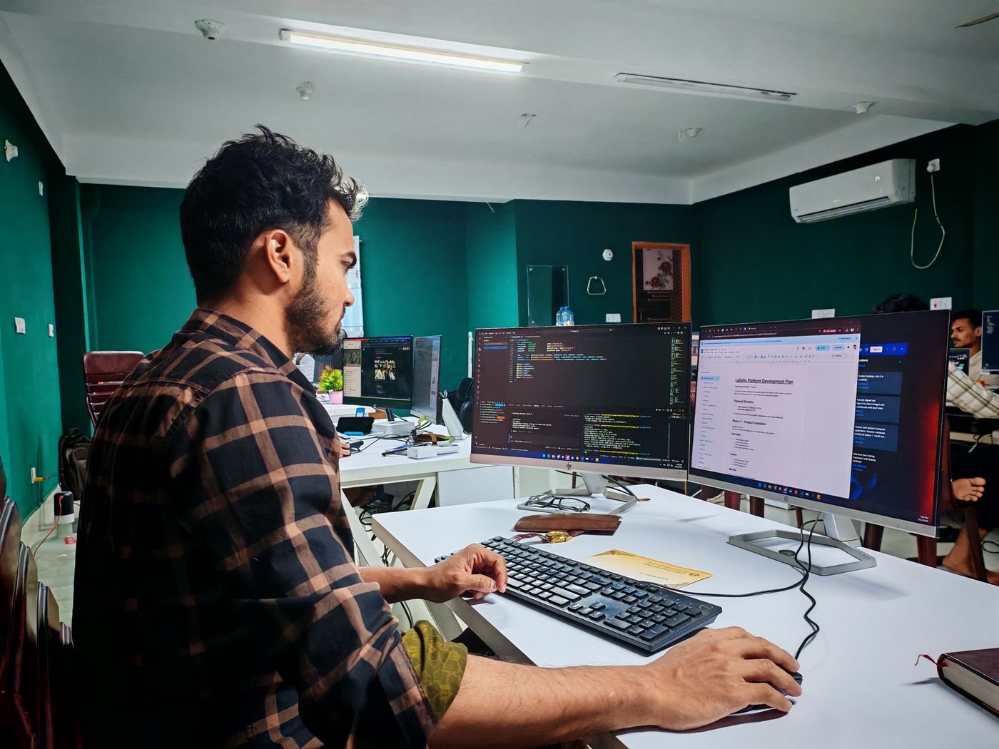 Software development workspace with code on screen